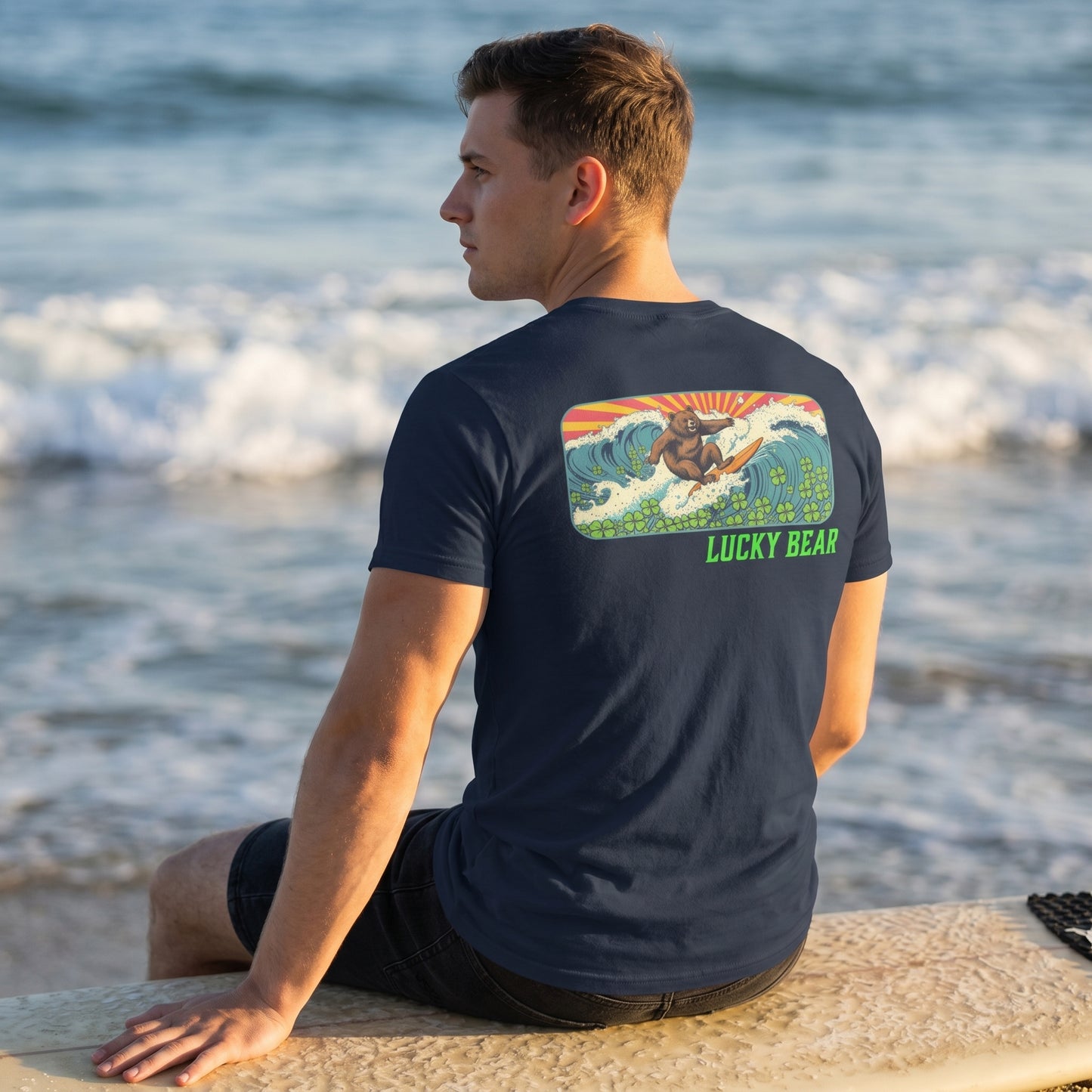 Model seated on surfboard wearing Retro Surfing Bear Tee, emphasizing fabric details and vintage design.