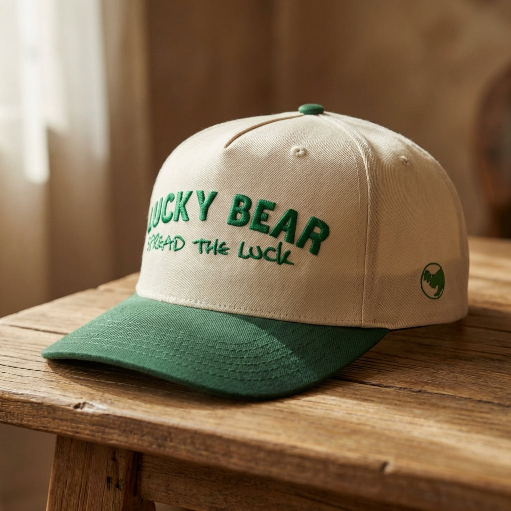 Close-up of Spread the Luck cap on a textured wooden surface highlighting fabric and stitching.