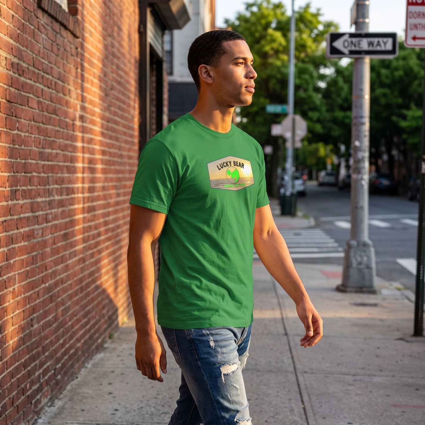 Model walking along city sidewalk wearing Spread the Luck Sunset tee during late afternoon sunlight.