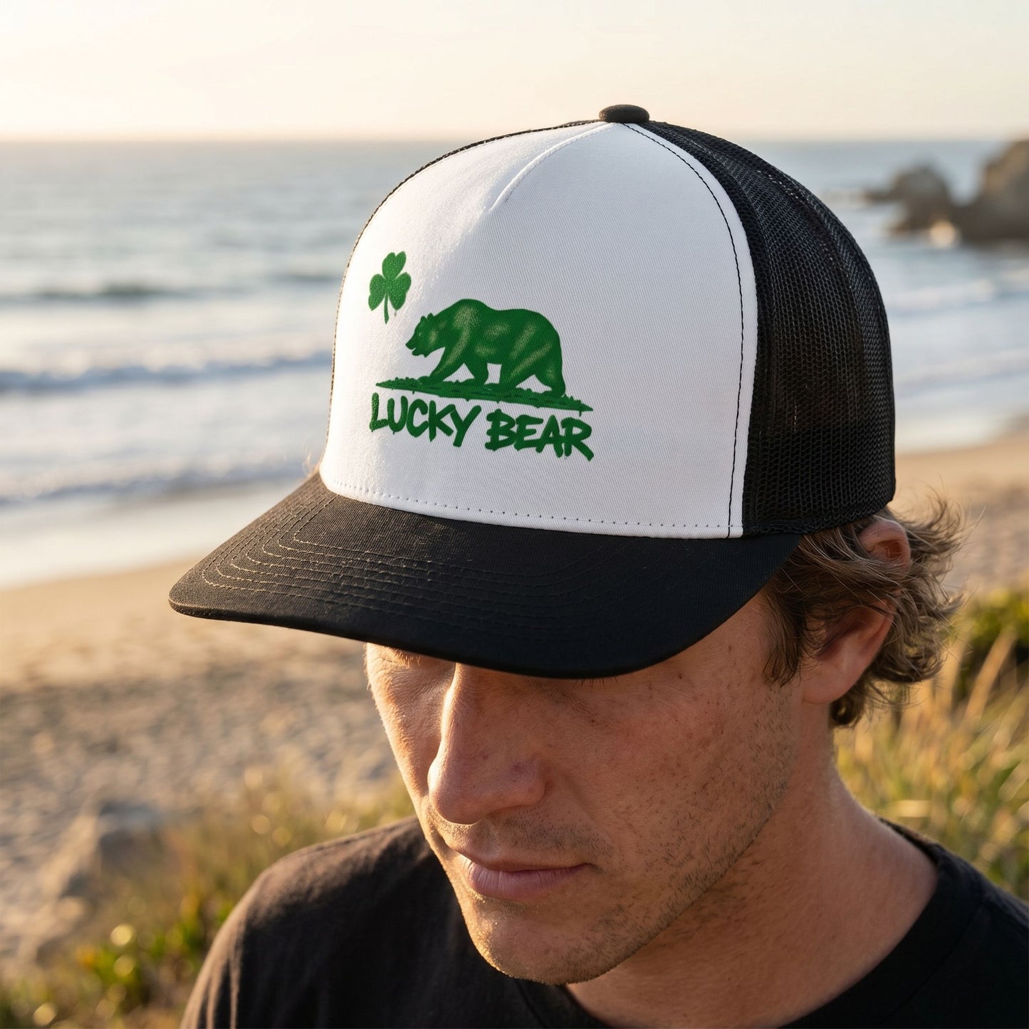 Close-up of worn Lucky Republic Trucker Cap by a model in golden hour sunlight, showing front panel and mesh side details.
