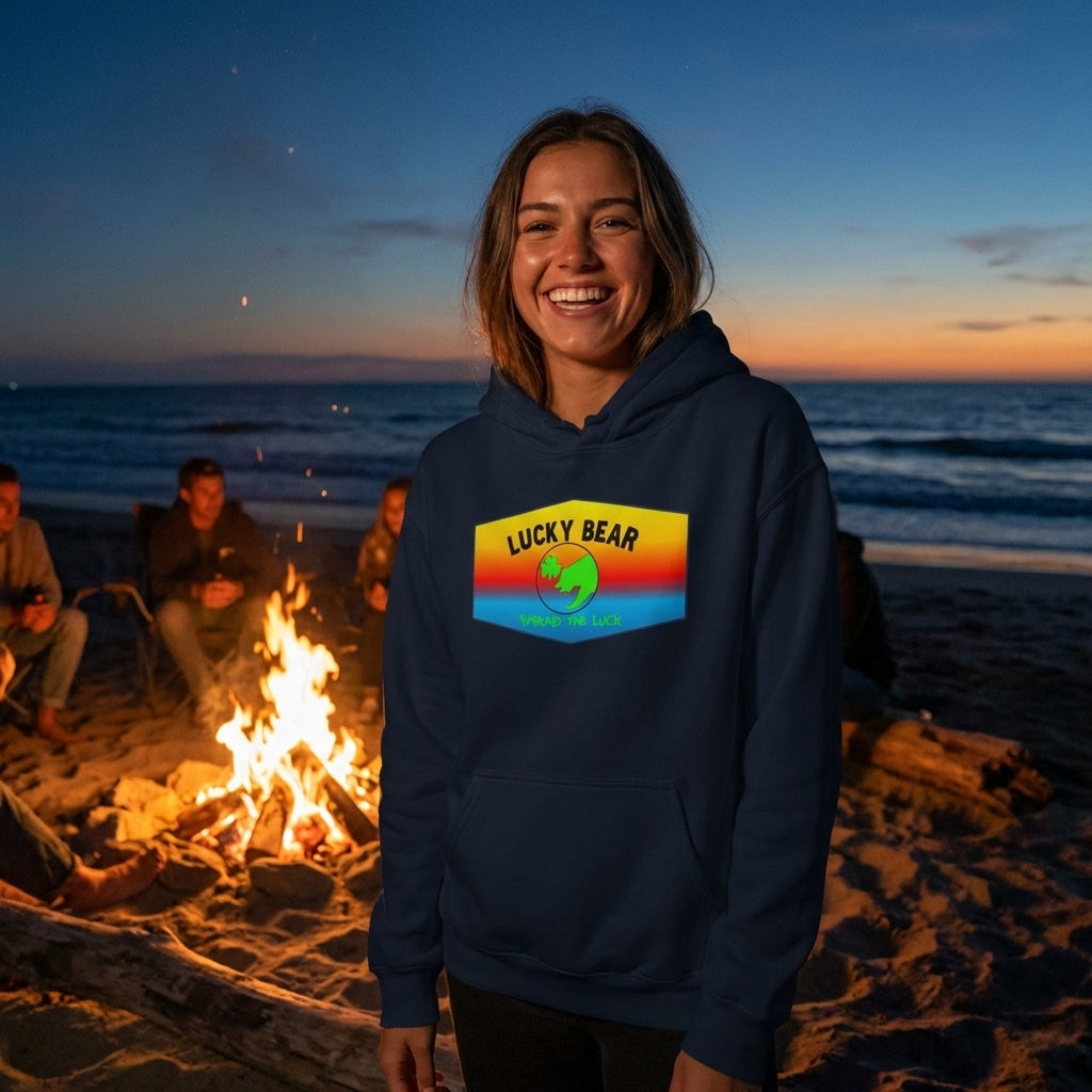 Close-up of a smiling person in navy hooded sweatshirt near shoreline after dark, highlighting the ombre fabric’s micro-texture and subtle fibers under sunset glow.