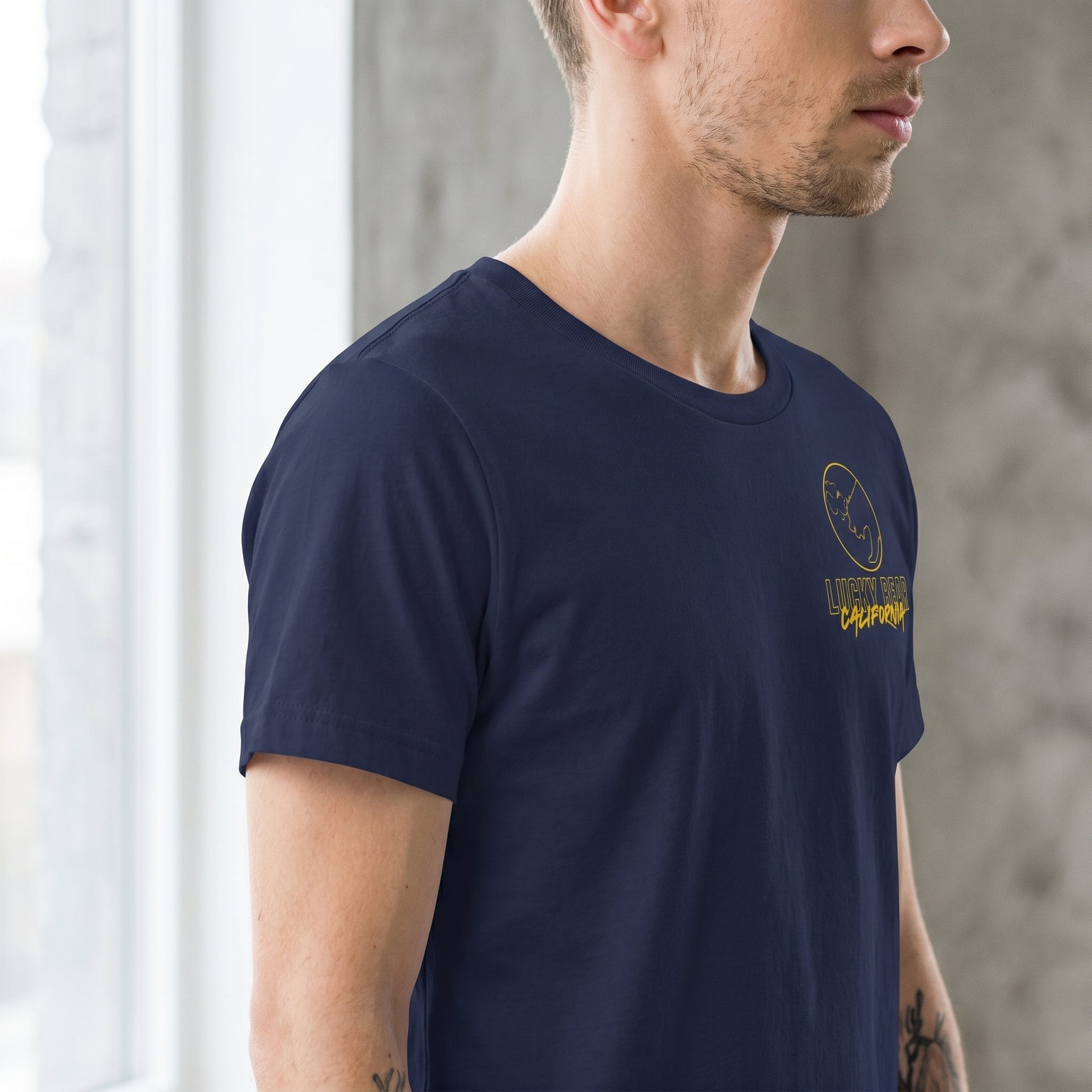 Close-up of collar and shoulder of the Stay Golden Lucky Bear t-shirt, emphasizing reinforced stitching and high-quality fabric.