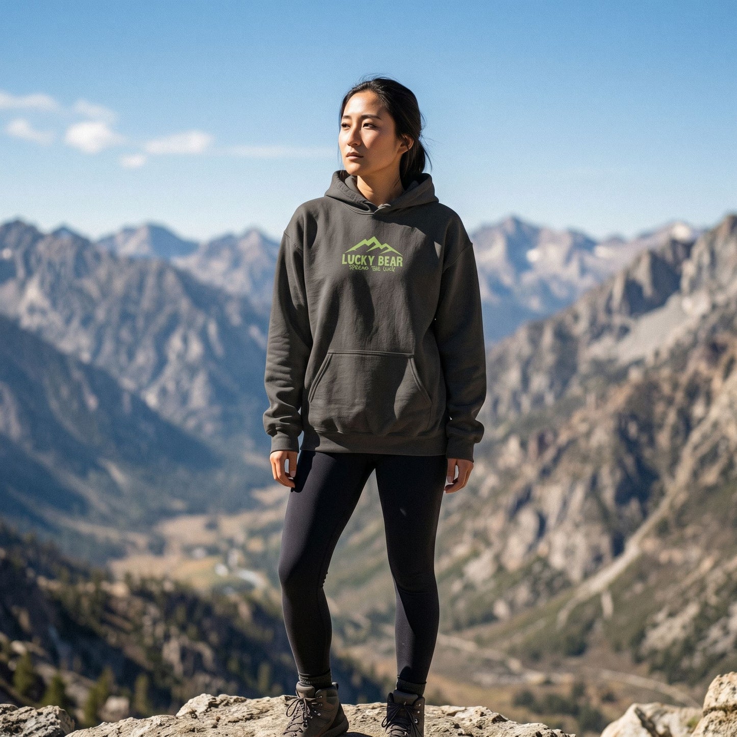 Full-body view of model wearing Sierra Summit hoodie in mountain landscape, highlighting relaxed fit and outdoor adventure style.