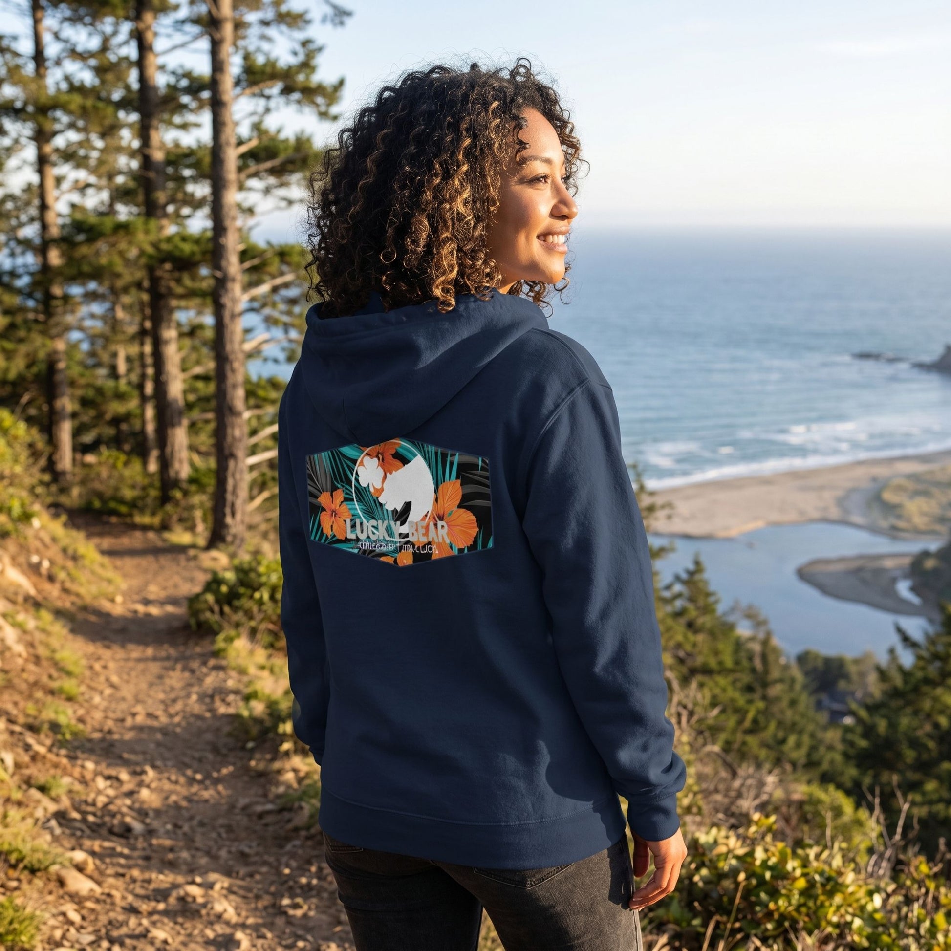Model wearing Lucky Bear Tropical Zip Up Hoodie zipped up in a relaxed outdoors near a mountain trail or beach.
