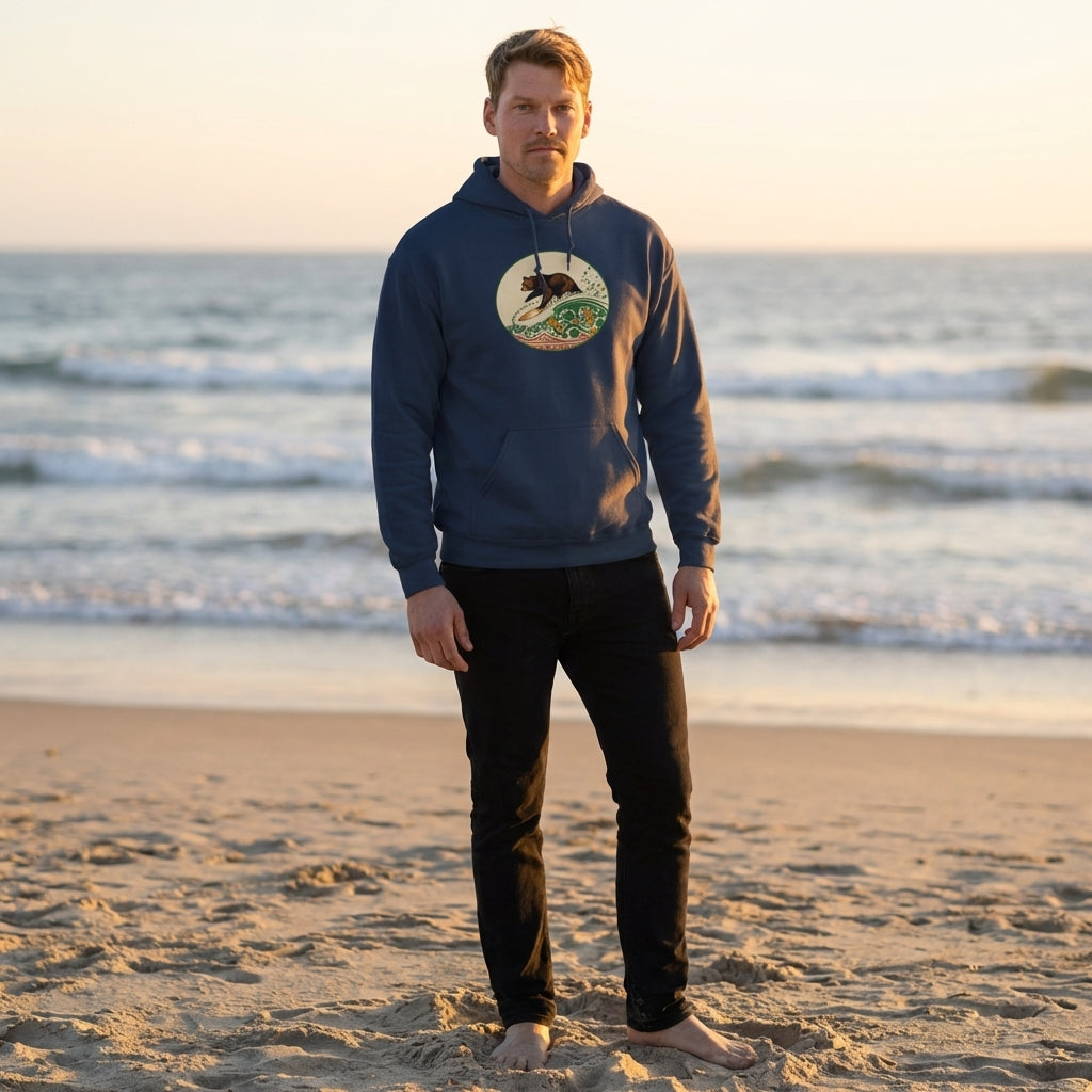 Model wearing navy hoodie on the beach during golden hour, with ocean background and relaxed surf community vibe.