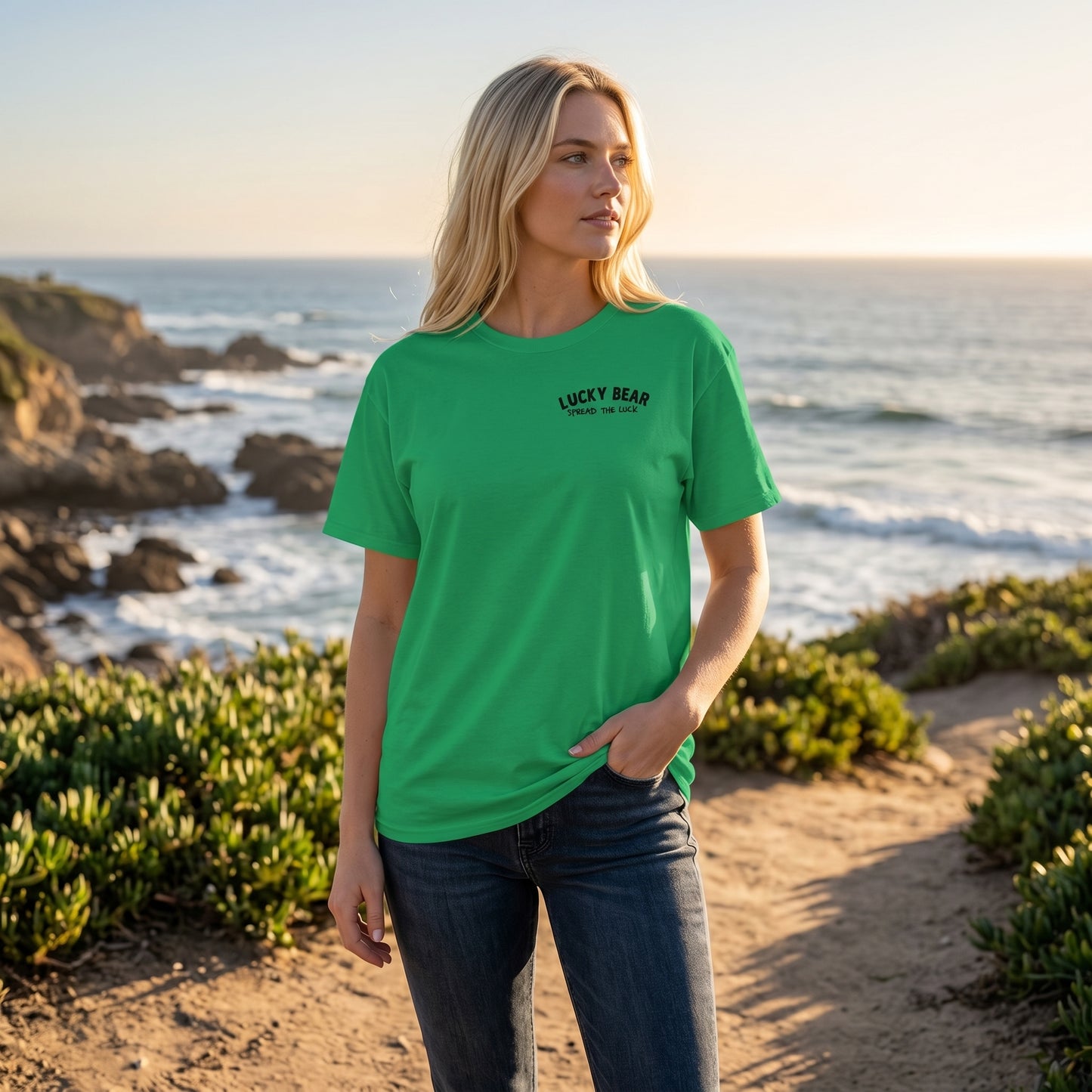 Blonde female model wearing the Spread the Luck ombre sunset classic tee outdoors, showcasing the relaxed fit and fabric colors.