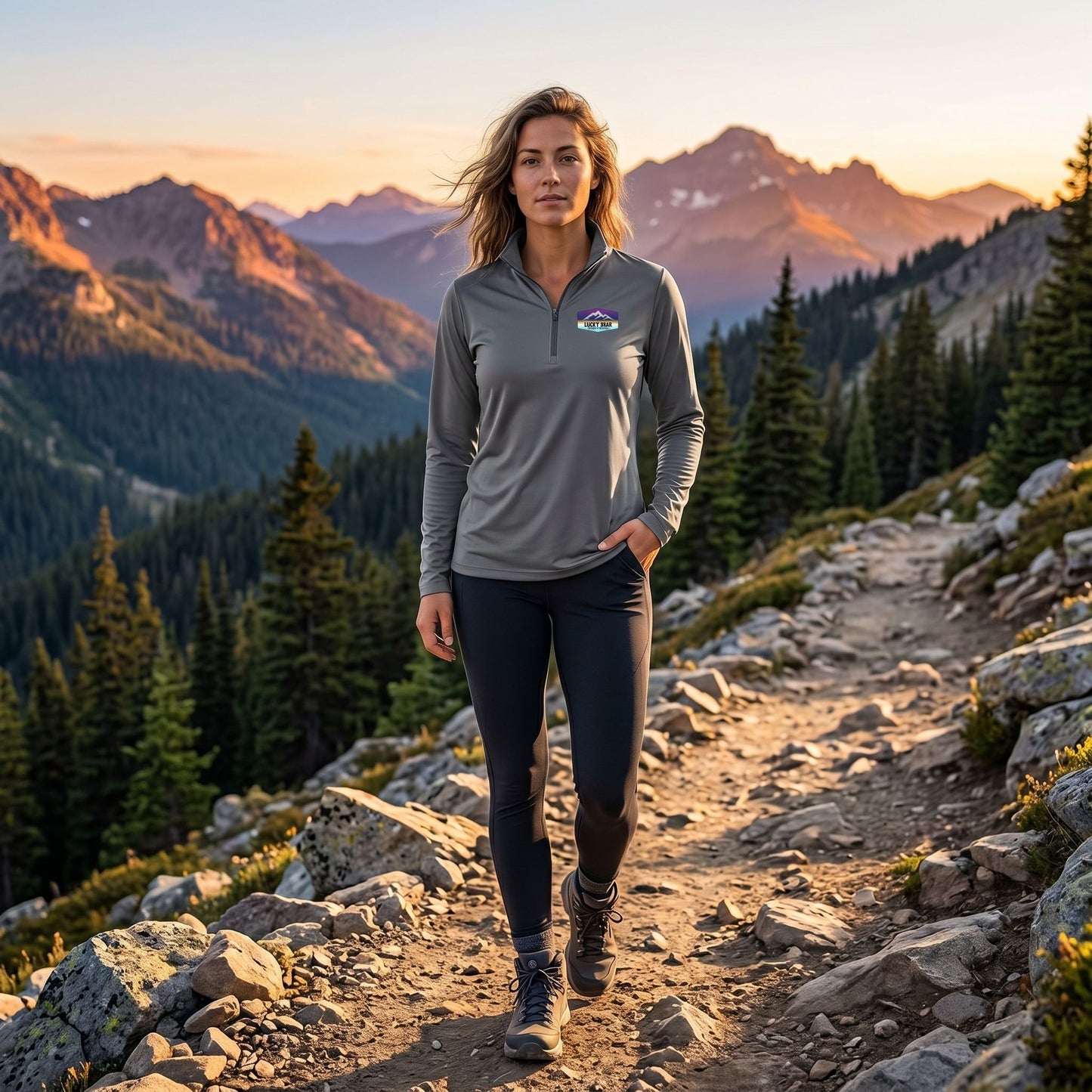 Full-body shot of a model in Sierra Sunset quarter-zip pullover on rocky mountain trail showcasing relaxed fit and outdoor adventure.