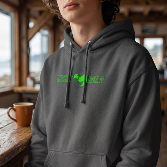 Close-up of Lucky Bear classic unisex heavyweight hoodie in gray, highlighting textured fabric and cozy knit material, in a warm indoor setting.