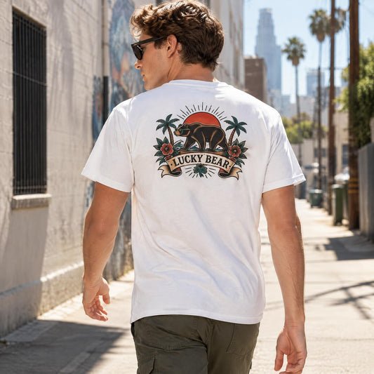 Lucky Bear Heritage Tee with vintage bear back graphic worn by a model walking in a sunlit urban alleyway.