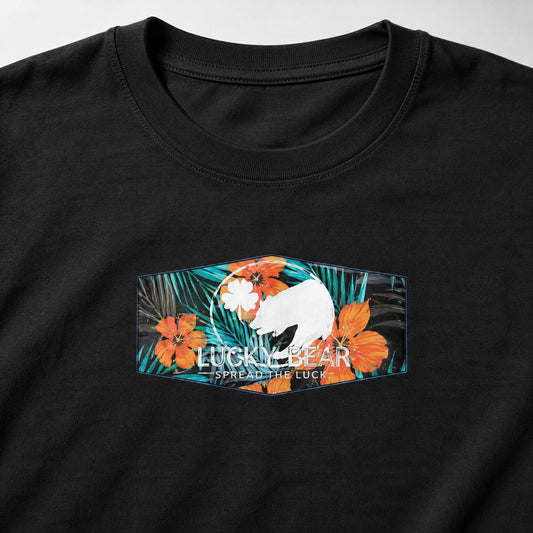 Close-up of the Lucky Bear tropical hibiscus graphic and logo printed on cotton fabric.