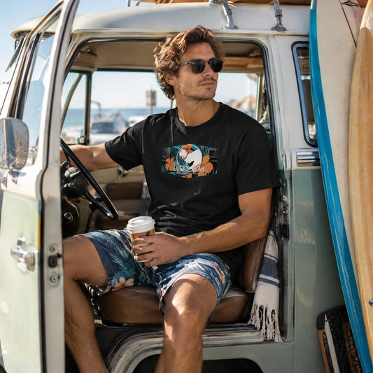 Lucky Bear tropical hibiscus t-shirt worn by a model inside a vintage VW van with surfboards at a beach parking lot.