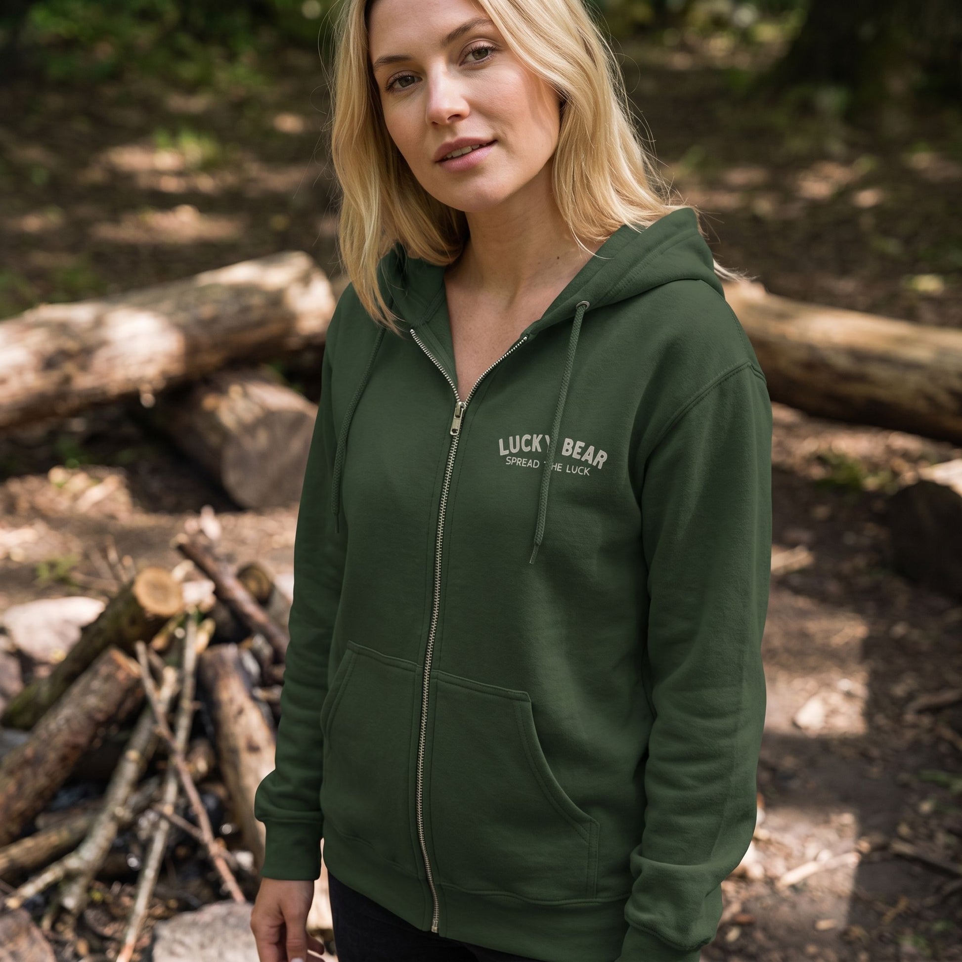 Close-up of Lucky Bear Tropical Zip Up Hoodie showing fleece texture, metallic zipper, front pockets, and graphic print with a cozy campfire background.