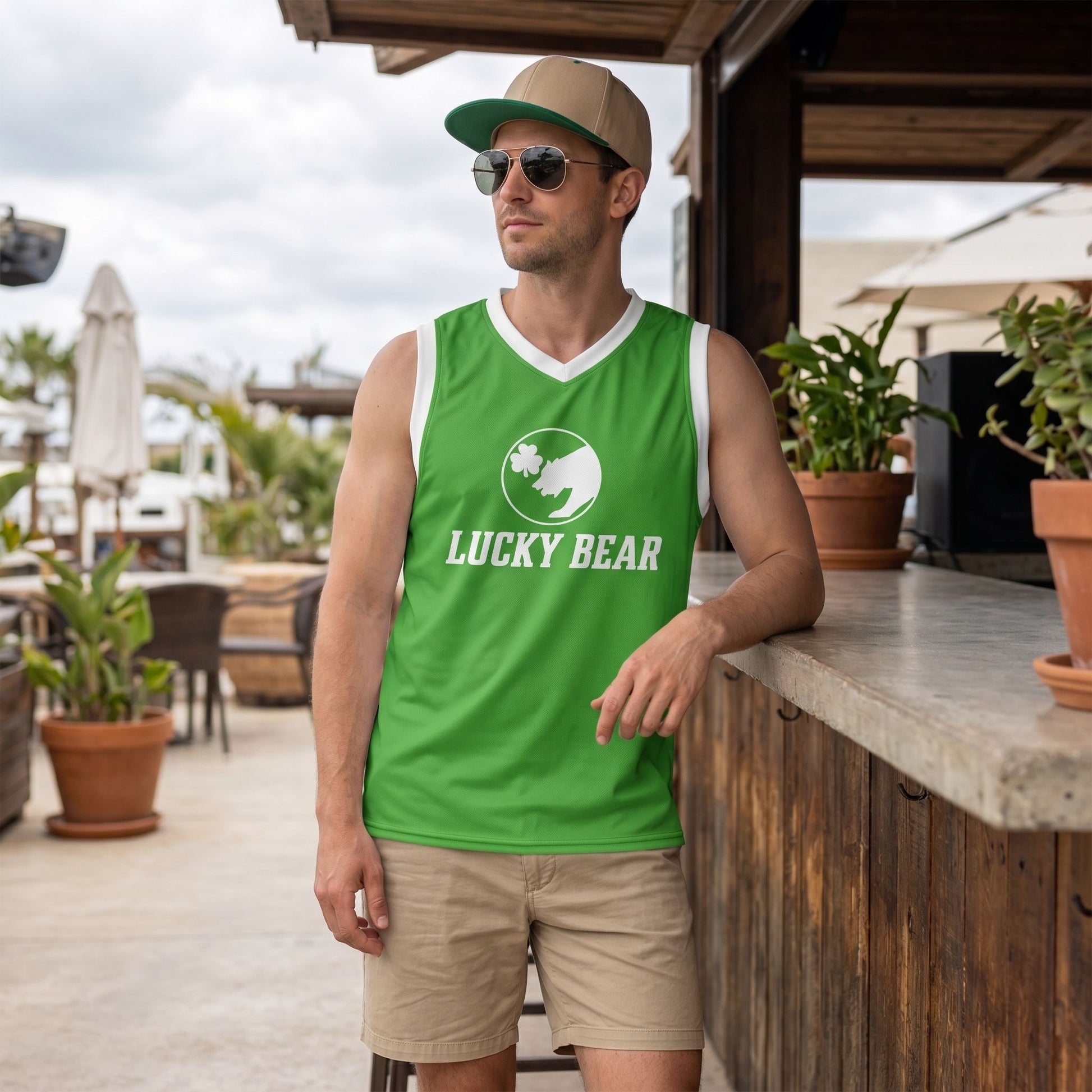Male model wearing the Lucky Bear Basketball Jersey at an outdoor restaurant, emphasizing the vibrant recycled polyester fabric, subtle stretch, and eco-conscious style.