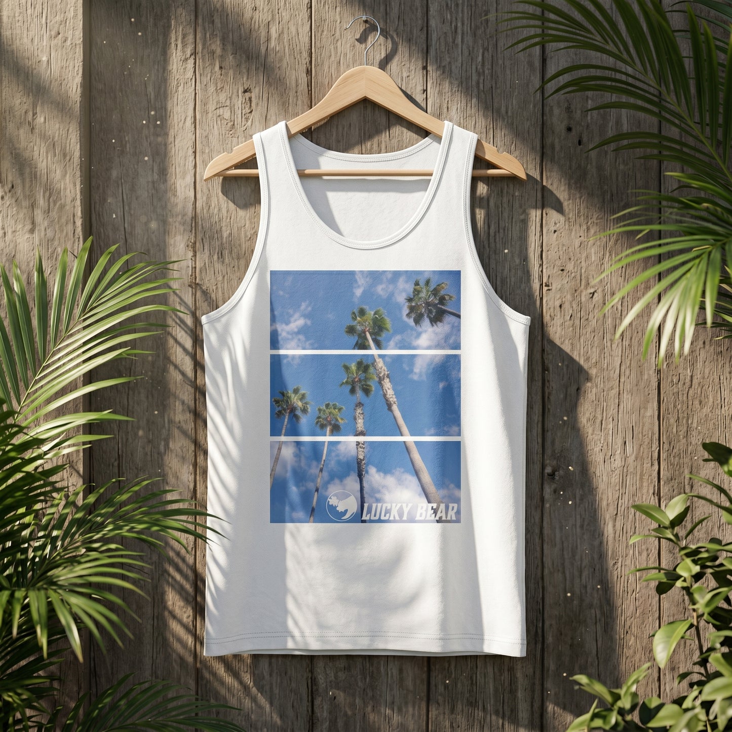Product shot of Palm View Tank Top on hanger in rustic outdoor setting, highlighting fabric and stitching.