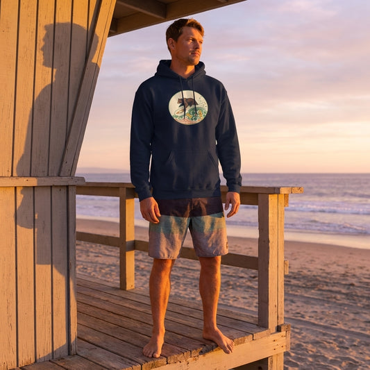 Full-body view of a model wearing navy hoodie from Old School Surf Club on lifeguard tower at the beach during golden hour, casual boardshorts, sunny atmosphere.