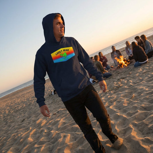 Person walking along sand dunes at dusk in navy ombre sunset hoodie, capturing flowing fabric texture and golden hour lighting with distant firelight.