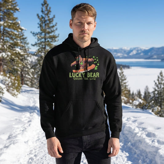High-resolution close-up of Sierra Bear unisex hoodie worn on a mountain trail with pine trees and snow, highlighting fabric texture and stitching.