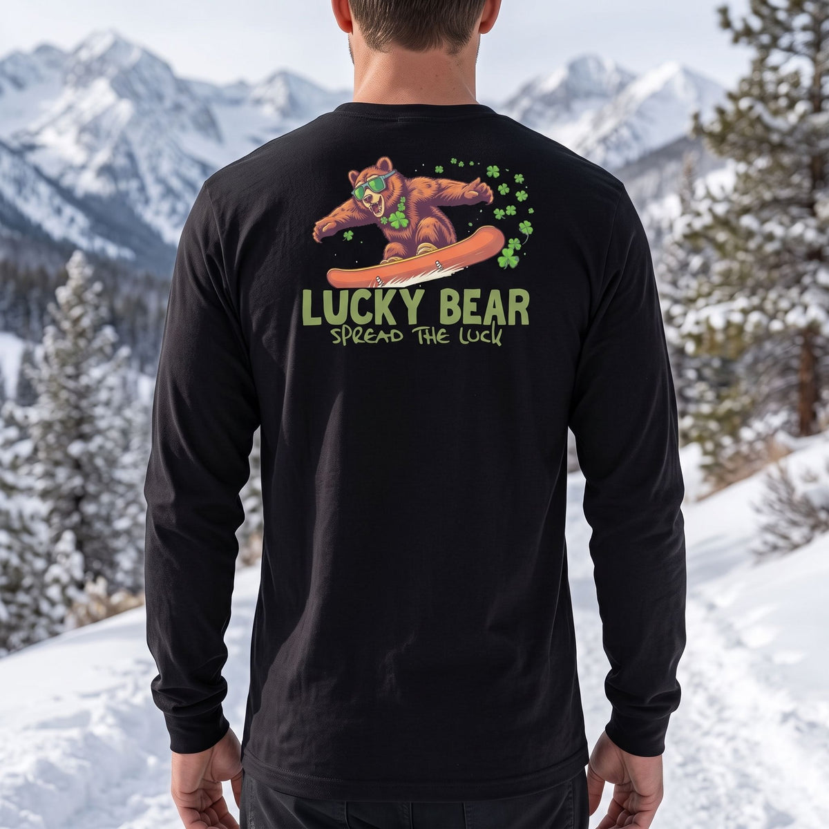 Close-up of Sierra Shredding Bear long sleeve shirt on model standing on snowy trail in mountain scenery.