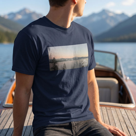Close-up of Sierra Sunset Tee on a model on a boat with mountain landscape, showcasing detailed textured fabric and natural sunlight.