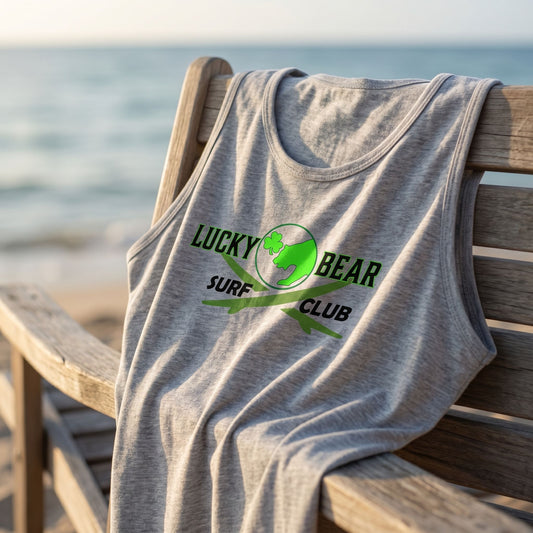 Close-up of Surf Club logo tank top fabric draped on a beach chair with ocean background, highlighting soft texture and weave in warm afternoon light.
