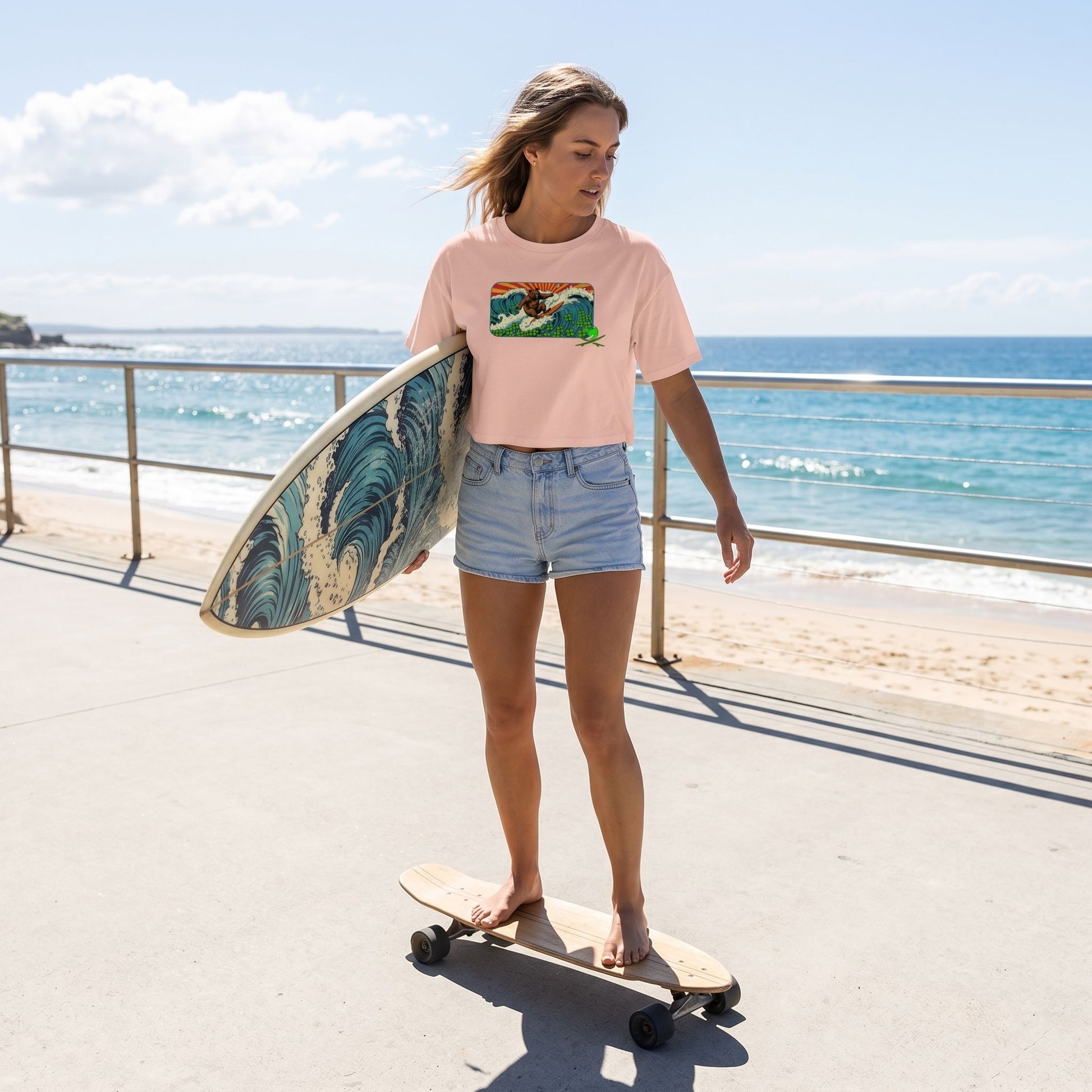 Model wearing Surf Club Retro Bear women's crop top outdoors, skateboarding with surfboard, sunlight highlighting fabric micro-details.